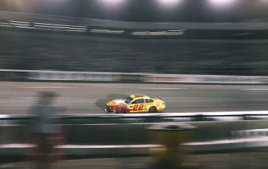 NASCAR driver races around a bend at Dover Motor Speedway